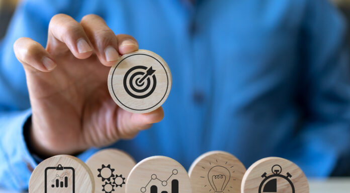 How to Align Product Strategy with Business Goals Hand holding wood block choose target icon business