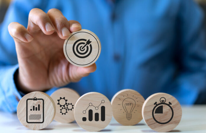 Hand holding wood block choose target icon business