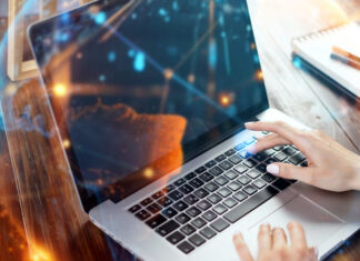 person typing on computer in web scraping