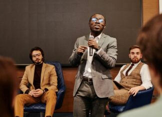 Developing In-House Experts to Strengthen Your B2B Brand Authority A Man Speaking Holding a Microphone
