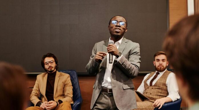 Developing In-House Experts to Strengthen Your B2B Brand Authority A Man Speaking Holding a Microphone