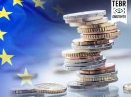 A Politically and Economically Weakened Europe Enters the Second Trump Era European flag with coins stacked on each other in different positions/Tariff