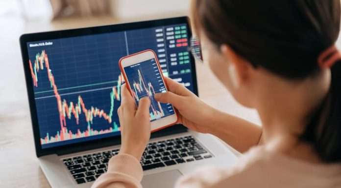 What is Crypto Trading API, and How Does It Work? Woman crypto trader investor broker using smartphone app and laptop executing financial stock trade market trading order to buy or sell cryptocurrency - API