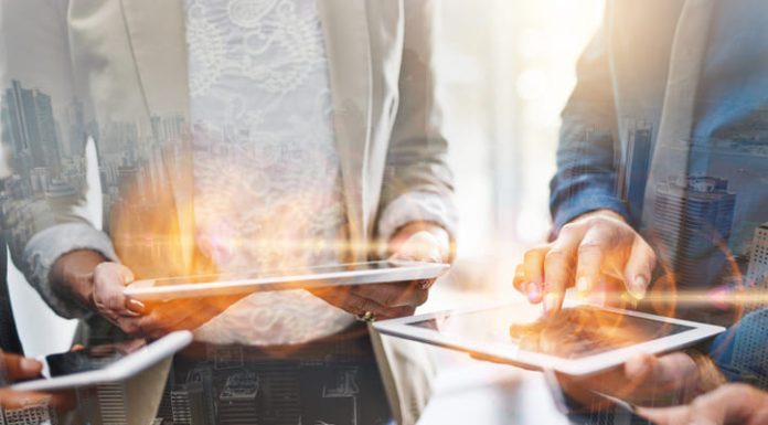 Unleashing Business Potential: Maximizing Technology’s Power Tablet and group overlay of business people networking on digital technology