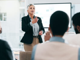 Business people, feedback and woman with presentation, seminar and questions with partnership, talent, corporate training and discussion.