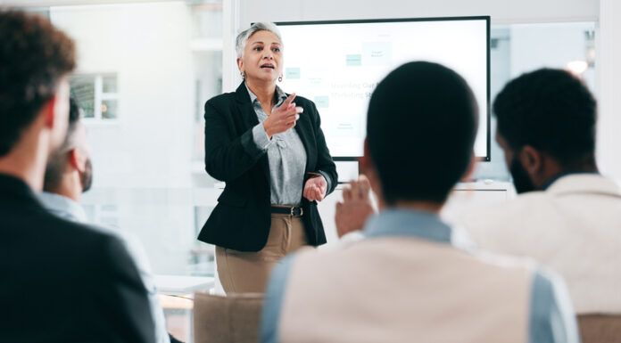 How Coaching Leaders Can Drive Talent Mobility and Address Workforce Challenges Business people, feedback and woman with presentation, seminar and questions with partnership, talent, corporate training and discussion.
