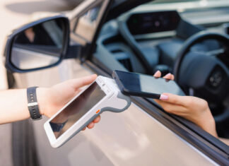 girl driver makes NFC payment with her mobile phone, contactless payment method for services