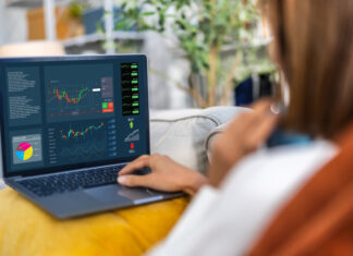 Successful trader use laptop trading stock exchange graph money, global economic