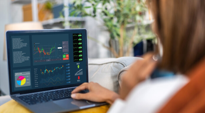 INFINOX Reviews and a Detailed Overview of the Broker’s Functionality Successful trader use laptop trading stock exchange graph money, global economic