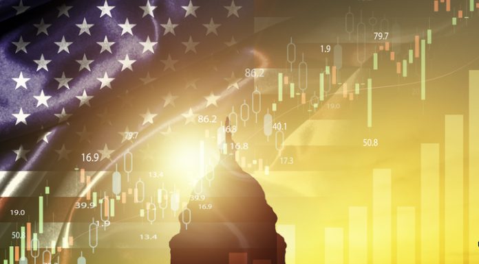 Inflation, Fed Policies, and Trump’s Economic Vision Silhouette of White House with united state of America flag and stock market chart for USA election president related with economy and investment