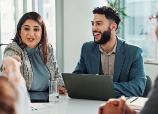 Business people and laptop with handshake in meeting
