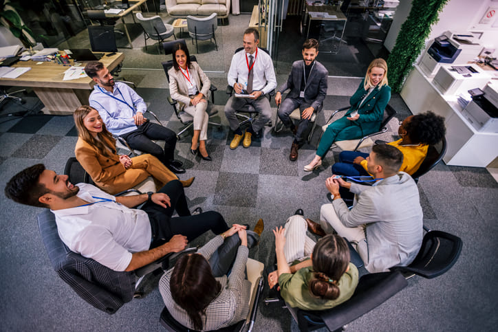 Business people sitting in circle and talking
