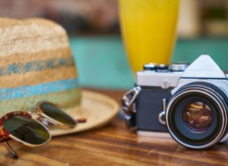 sun glasses, hat and camera for journey equipment - Hastings Currency Exchange Made Easy