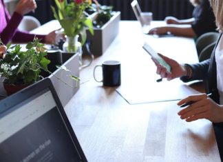 Business Visa to Azerbaijan for Pakistan Citizens: Conditions for Obtaining It Person Holding Smartphone in Front of Table