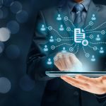 What does McKinsey’s 2030 Vision Mean for Data Management this Year?  Businessman holding a tablet for Corporate data management system