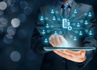 What does McKinsey’s 2030 Vision Mean for Data Management this Year? Businessman holding a tablet for Corporate data management system