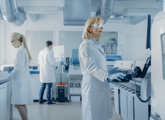 Team of Research Scientists Working On Computer, with Medical Equipment