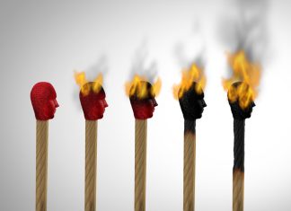 Row of burnt matches, one has survived and kept its red head,