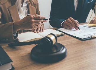 What Should You Do After an Injury? A Lawyer’s Guide Judge gavel with Justice lawyers having team meeting at law firm.