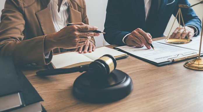 Judge gavel with Justice lawyers having team meeting at law firm.