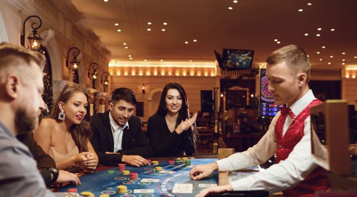 eople gamble at a poker table in a casino