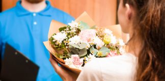 Fresh & Stunning Flowers with Reliable Flower Delivery to Toronto courier hands bouquet to young woman, flower delivery