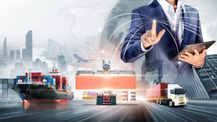 iStock-1370740473 (1) Businessman touching virtual screen world map of Global logistics network distribution, Container cargo freight ship at industrial port for logistics Import export background, Smart technology