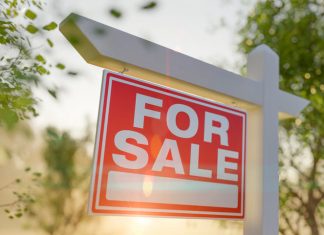 For Sale Real Estate Sign in Front of property