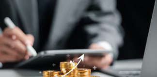 AFG Investments Offers Multi-Device Compatibility for Greater Convenience Businessman collecting coins with profit chart analysis business growth, profit growth management and corporate financial statistics