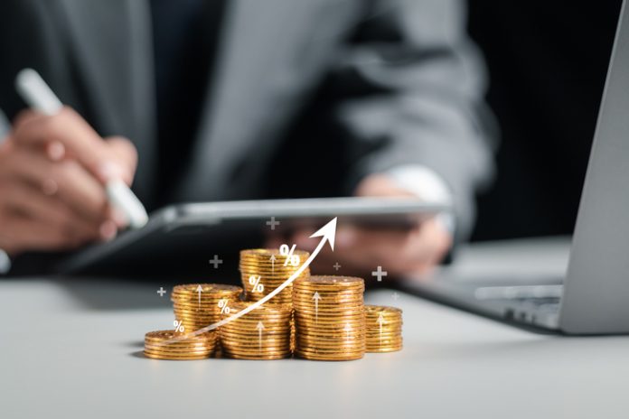 Businessman collecting coins with profit chart analysis business growth, profit growth management and corporate financial statistics