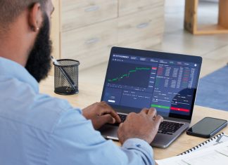 Best Jurisdictions for Crypto Entrepreneurs Laptop, finance and stock market with a man broker working in his office for trading investment or growth