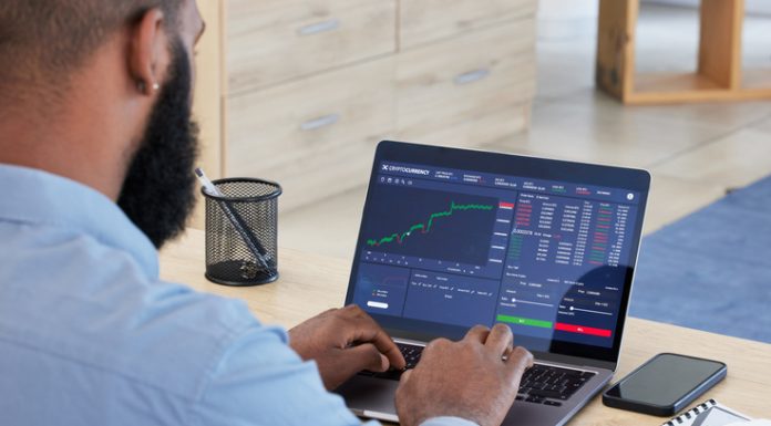 Best Jurisdictions for Crypto Entrepreneurs Laptop, finance and stock market with a man broker working in his office for trading investment or growth