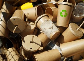 Transforming Paper Cup Recycling for a Sustainable Future Recycle symbol on disposable brown paper cups and plastic glasses used from coffee cafe, restaurants, takeaways.