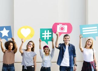 holding up thought bubbles with social media concept icons