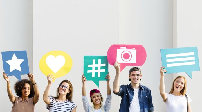 holding up thought bubbles with social media concept icons