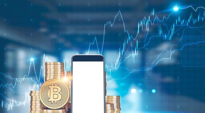 How to Make Passive Income with Crypto in 2025 Pile of bitcoins with a large mock up screen smartphone in the foreground