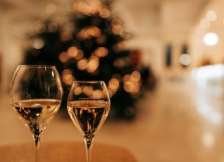 two glass of wine on a table in front of a Christmas tree