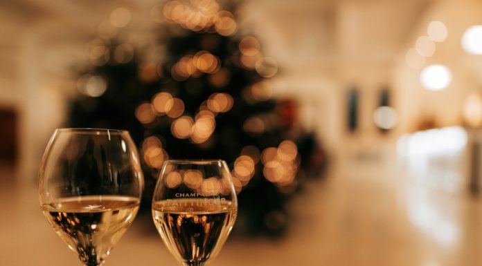 two glass of wine on a table in front of a Christmas tree
