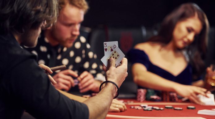 group of people playing igaming in casino together.