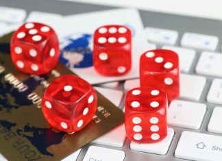 Dice plastic credit bank cards and computer keyboard on table