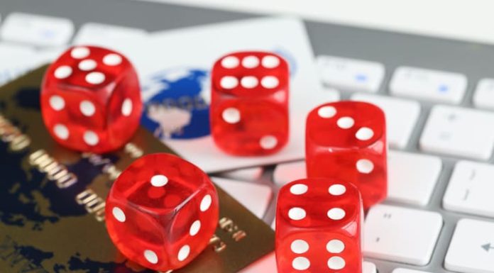 Dice plastic credit bank cards and computer keyboard on table