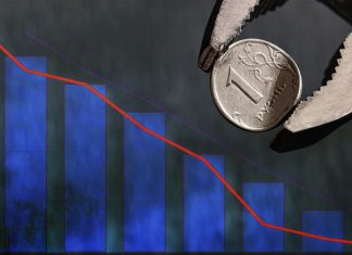 Crypto CFDs in 2025 – What Should We Expect? Seekapa Analysts Weigh In Wrench holds in vise bent metal coin with a face value of 1 Russian ruble