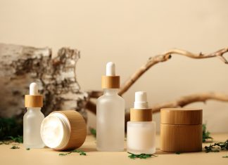 SPA natural organic cosmetics packaging design. Set of transparent glass bottles, moisturizer cream in wooden jars.