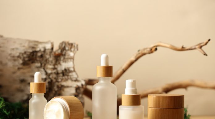 SPA natural organic cosmetics packaging design. Set of transparent glass bottles, moisturizer cream in wooden jars.