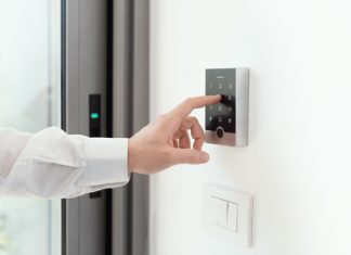 Man setting an alarm code for home security