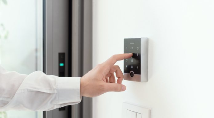 Man setting an alarm code for home security