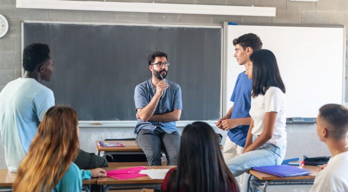 Students having conversation with their professor