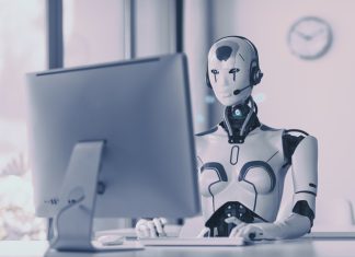 Understanding Agentic AI: A Business Primer Android AI robot sitting at the desk and working in the office: artificial intelligence, business and automation concept