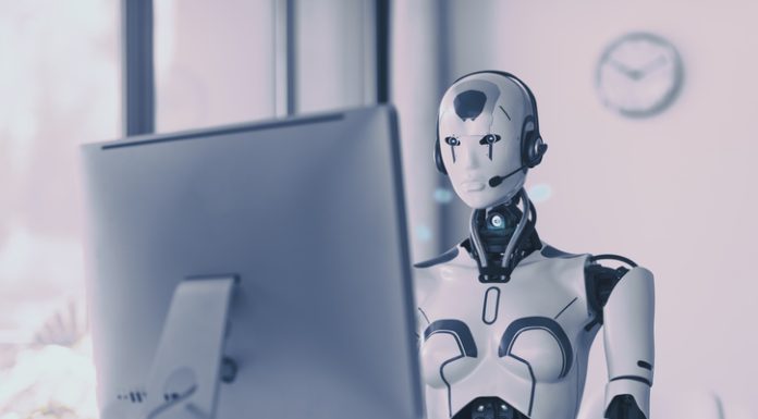 Understanding Agentic AI: A Business Primer Android AI robot sitting at the desk and working in the office: artificial intelligence, business and automation concept