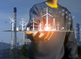 The Crucial Impact of Project Management on Clean Energy Man holding digital tablet for developing clean energy such as wind energy for energy sustainability.